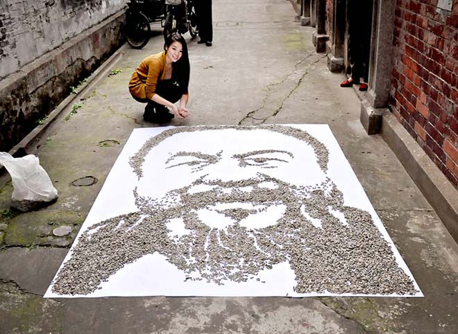 Red Hong Yi - Ai Weiwei portrait made of 100,000/7kgs of sunflower seeds on an old alleyway in Shanghai.