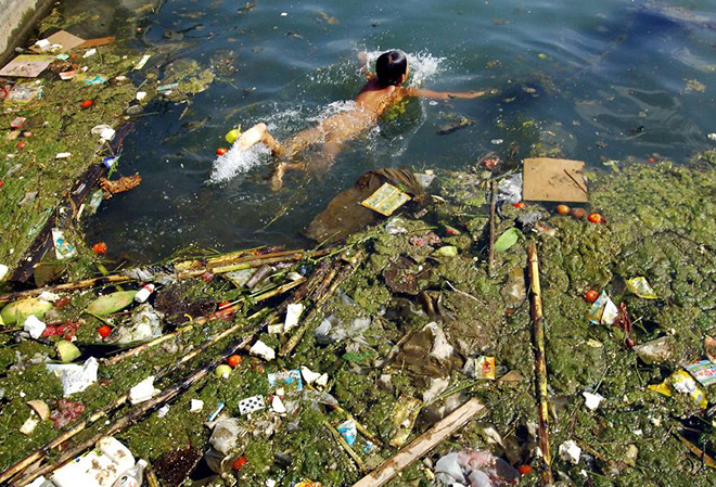 A child swims in a polluted reservoir in Pingba, southwest China's Guizhou province, Sept. 2, 2006 A child swims in a polluted reservoir in Pingba, southwest China's Guizhou province, Sept. 2, 2006