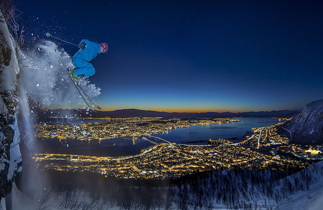 Audun Rikardsen - Arctic urban skiing,  Tromsø, Norway, Sport category. A friend of mine drops a 10 m high cliff on skis in the polar night above the Tromsø town in Northern Norway. (panorama of two pictures).