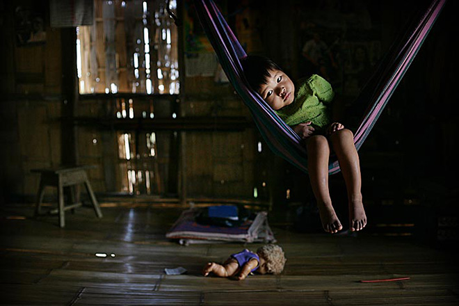 ©Timothy Allen - Displaced Bru girl in hammock, Naisingpara refugee camp, Tripura, North East States, India