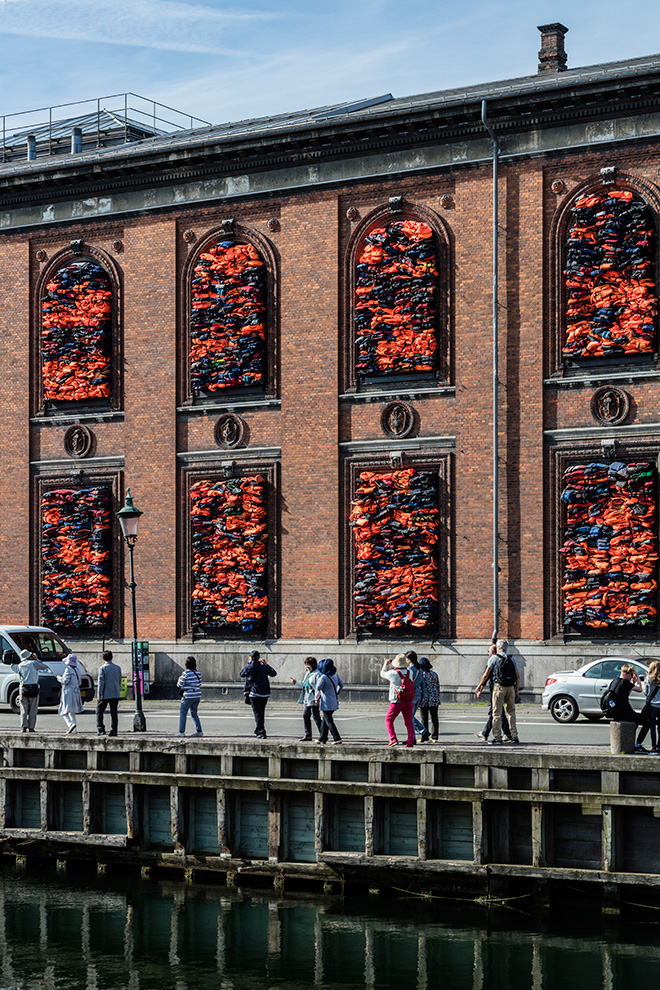 Ai Weiwei - Soleil Levant, 2017. Installation view, Kunsthal Charlottenborg, 2017. Life jackets in front of windows of facade. Courtesy of the artist. Photo by David Stjernholm.