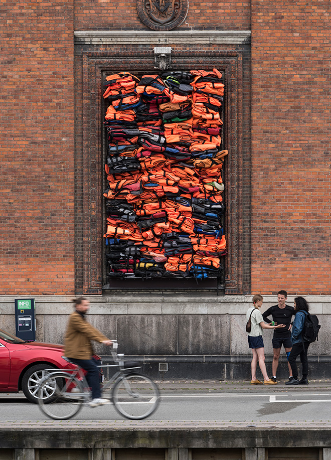 Ai Weiwei - Soleil Levant, 2017. Installation view, Kunsthal Charlottenborg, 2017. Life jackets in front of windows of facade. Courtesy of the artist. Photo by David Stjernholm.