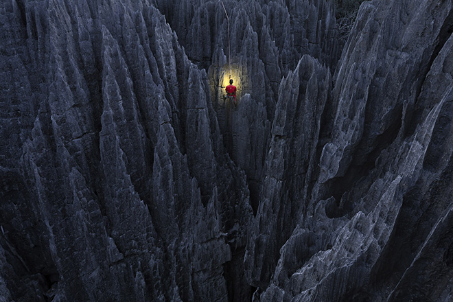 Bemaraha NP, Madagascar.  Marsel Van Oosten, Netherlands. Commended, Special Mention Travel, Travel Photographer of the Year 2018. (The Grand Tsingys are a rare geological phenomena. The rocks are razor sharp. I climbed up during the night to be able to photograph this climber in the early morning). (Photo: Ignacio Palacios/www.tpoty.com)
