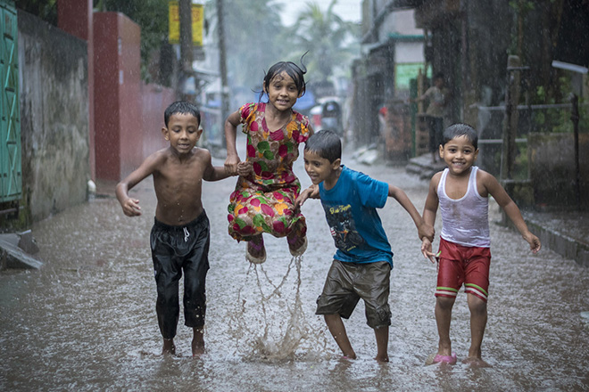 Akua, Sadar, Bangladesh. Fardin Oyan (age 16), USA. Winner, Young TPOTY 15-18, 2018. (Watching these kids playing in the rain, I covered my camera with a polythene bag and rushed out into the rain. We danced, laughed and played in the rain). (Photo: Fardin Oyan/www.tpoty.com)
