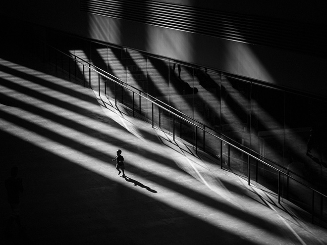 Tate Modern, Bankside, London, UK. Edmond Terakopian, UK. Special Mention Faces, People, Cultures, Travel Photographer of the Year 2018. (A child runs around whilst bathed in rays of sunlight in the Turbine Hall). (Photo: Edmond Terakopian/www.tpoty.com)