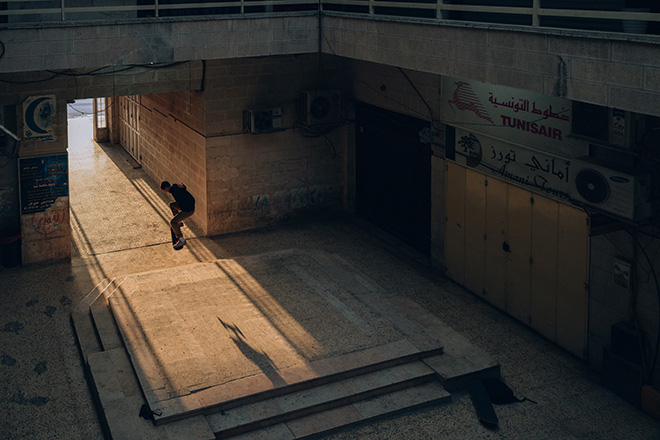 Maen Hammad - LANDING. Kareem, 17, a junior in high school, ollies down a set of stairs in a Ramallah shopping mall.
