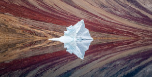 © Craig McGowan - Ice Reflections, Australia, Winner, Open, Landscape, 2020 Sony World Photography Awards. A solitary iceberg, set against the fjord walls in Northeast Greenland National Park.