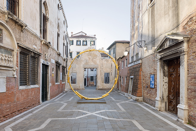 Ugo Rondinone - the sun II, 2018 Gilded bronze, 508 x 515.5 x 71 cm. Exhibition view: Ugo Rondinone, burn shine fly, Scuola Grande San Giovanni Evangelista, Venice, 2022. Courtesy the artist; Galerie Eva Presenhuber, Zurich; Esther Schipper, Berlin; Sadie Coles HQ, London; Gladstone, New York; Kamel Mennour, Paris; Kukje Gallery, Seoul. Photo © Andrea Rossetti