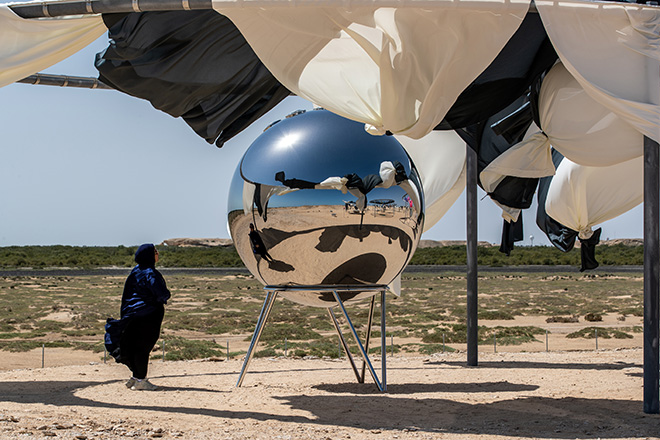 Rainbow incubator, 2023. Galvanized steel, textile (white, anthracite), solar lamp, stainless steel, glass prism, aluminium, paint (grey), plastic. 380 x 950 x 950 cm. Installation view: Olafur Eliasson: The curious desert, near the Al Thakhira Mangrove in Northern Qatar, 2023. Photo: Ali Faisal Al Anssari, Qatar Museum. Courtesy of the artist; neugerriemschneider, Berlin; Tanya Bonakdar Gallery, New York / Los Angeles.