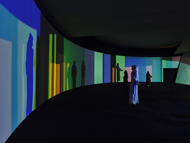 The living lighthouse, 2023. Steel, wood, paint (black), colour-effect filter glass (various colours), HMI lamps, motors, tripod, cables, electrical ballast. Dimensions variable. Installation view: Olafur Eliasson: The curious desert, National Museum of Qatar, Doha, 2023. Photo: Anders Sune Berg. Courtesy of the artist; neugerriemschneider, Berlin; Tanya Bonakdar Gallery, New York / Los Angeles