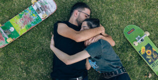 Maen Hammad - LANDING. Kilani and his girlfriend Tala caressing one another in a park in Haifa. Kilani crosses a checkpoint illegally to meet Tala every few weeks.