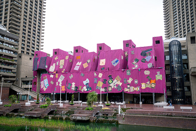 Ibrahim Mahama’s Purple Hibiscus during installation at the Barbican, 2024. Courtesy Ibrahim Mahama, Red Clay Tamale, Barbican Centre, London and White Cube.  © Pete Cadman, Barbican Centre.