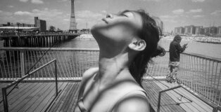 © Harvey Stein (USA) - Woman on Coney Island Pier Looking Skyward from the series 'Coney Island People 50 Years'. 1st place winner AAP Magazine #47: Shadows