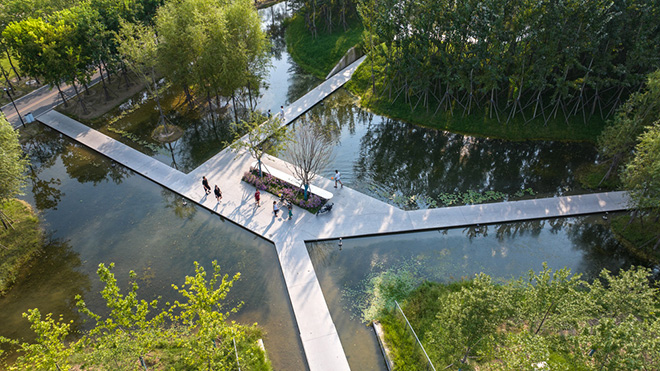 Turenscape - The Huaiyang Fuxi Cultural Park, Henan, China. Pathways navigate through craters and tunnels, with water by boardwalks kept safe per regulations, eliminating handrails. Photo credit: Turenscape Turenscape - The Huaiyang Fuxi Cultural Park, Henan, China. Pathways navigate through craters and tunnels, with water by boardwalks kept safe per regulations, eliminating handrails. Photo credit: Turenscape