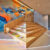 JSWD + Jim Clemes Ass. – Ecole Brouch: Primary School, Esch-sur-Alzette, Luxembourg. Entrance hall with seat steps, Artwork: Daniel Mac Lloyd. Photo credit: Andres Lejona
